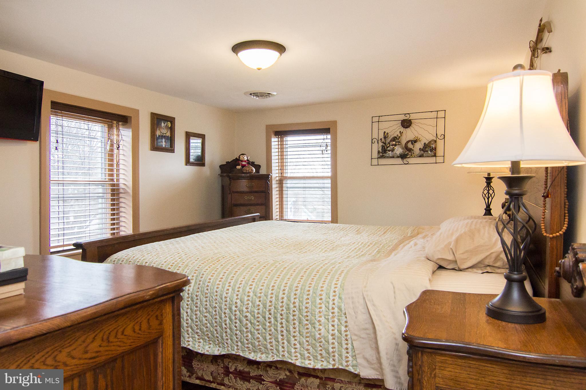 3358 Uniontown Road Westminster, MD 21158 - Photo 21 of 30 a bedroom with a bed and a flat screen tv