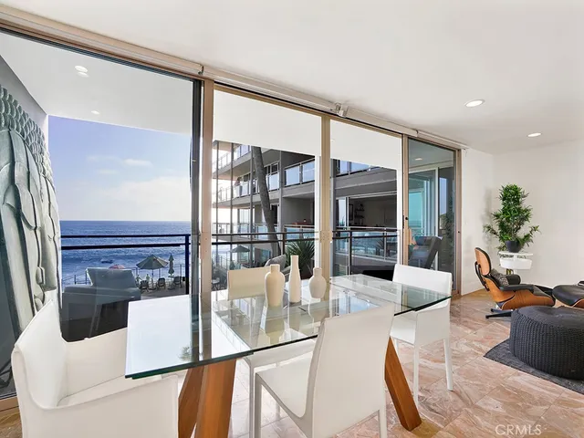 a view of a living room with furniture and large windows