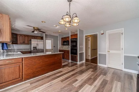 a kitchen with stainless steel appliances granite countertop a refrigerator and a sink