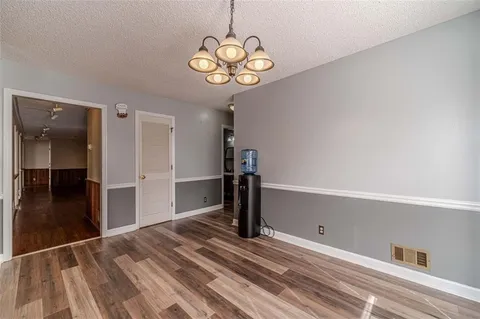 a kitchen with granite countertop a refrigerator and a sink