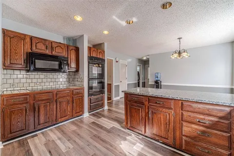 a view of a room with wooden floors and stairs