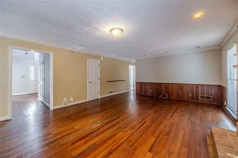a view of a room with wooden floor
