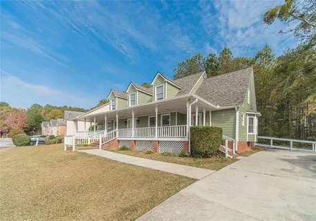 a front view of a house with a garden