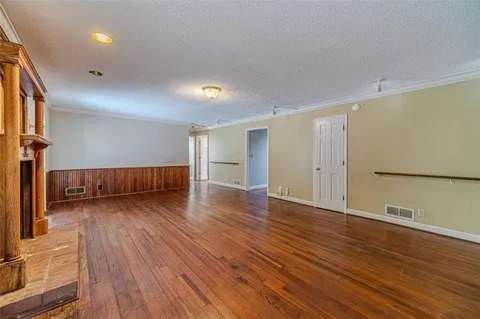 a view of a room with wooden floor