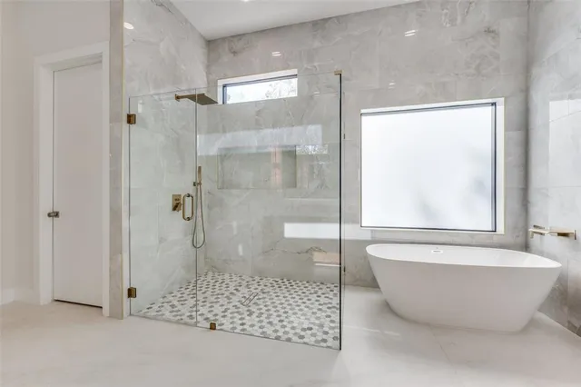 a bathroom with a bathtub and shower