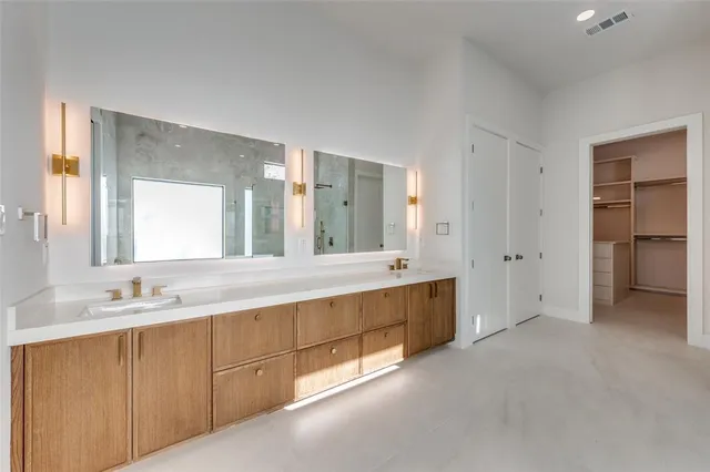 a bathroom with a double vanity sink and mirror