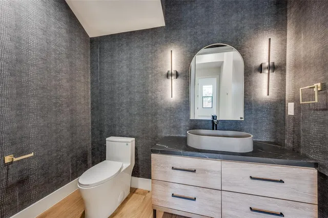 a bathroom with a toilet sink and mirror