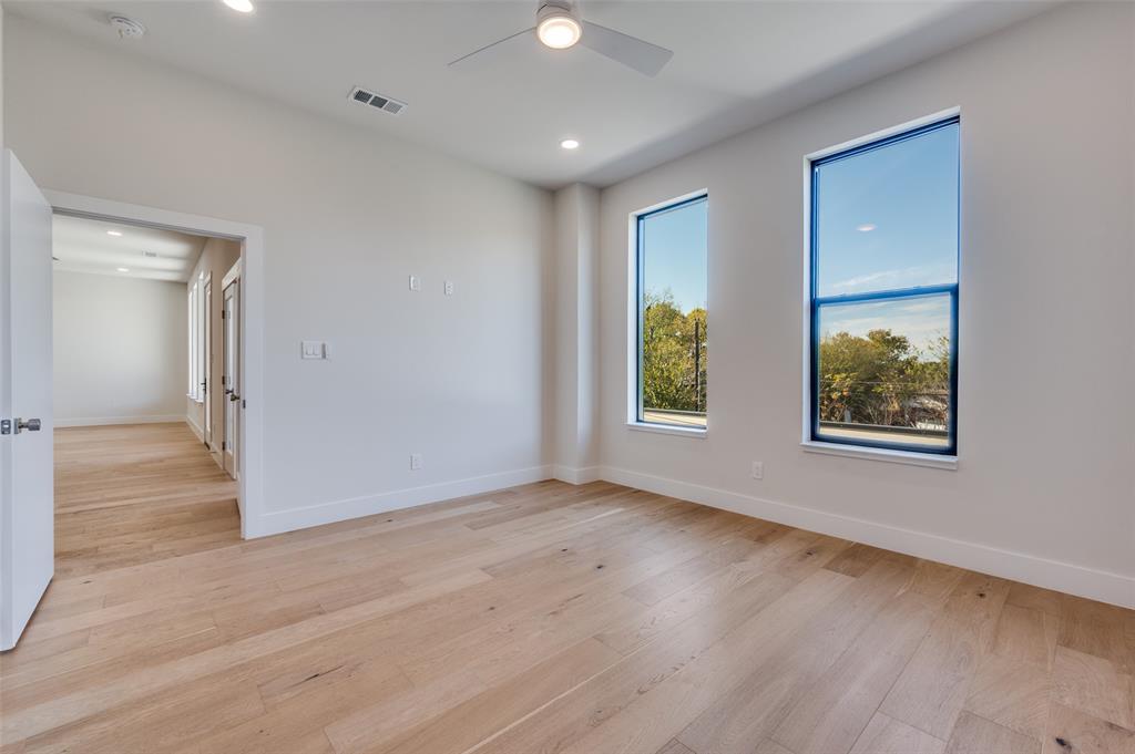 9409 Lenel Place Dallas, TX 75220 - Photo 26 of 36 an empty room with wooden floor and windows
