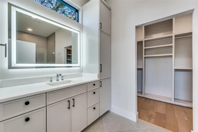 a bathroom with a double vanity sink and mirror