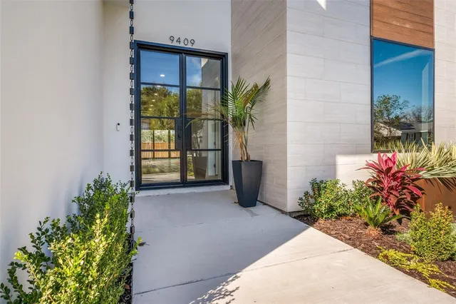 a view of a entryway of the house with flower pots