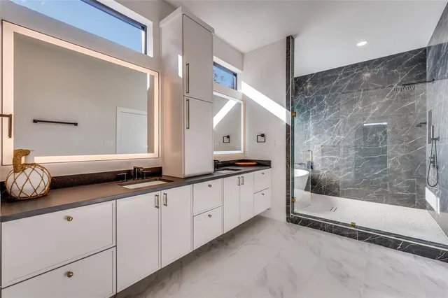a spacious bathroom with double sink and a mirror