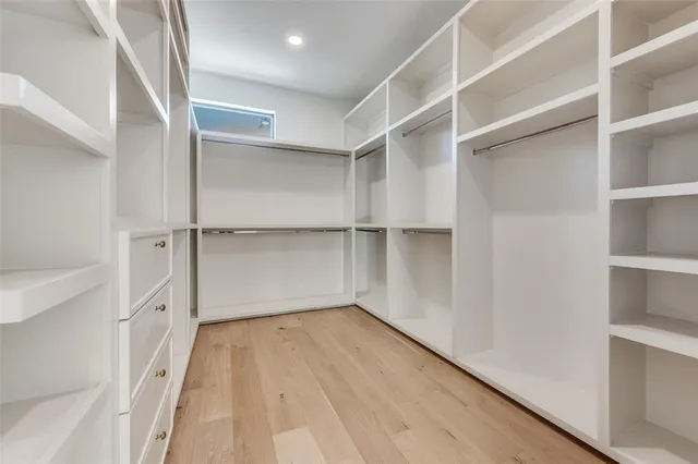 a view of walk in closet with empty racks