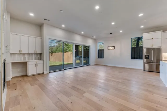 a view of a kitchen with a sink and a large window