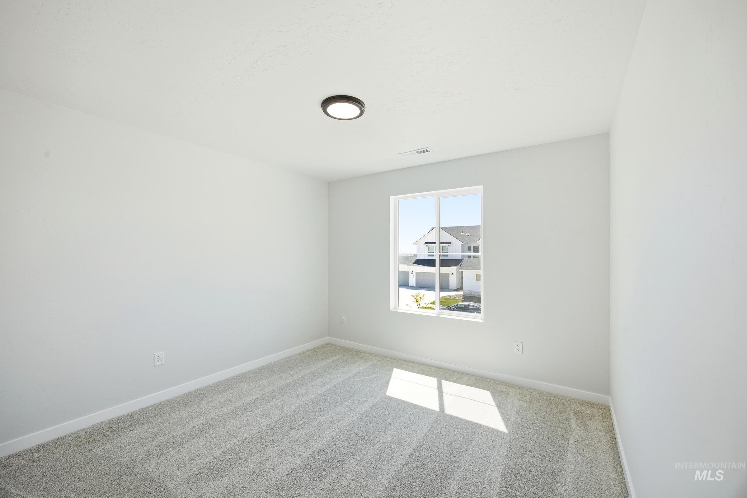 12841 Decatur Street Nampa, ID 83651 - Photo 19 of 30 Neutral-toned carpeting paired with white baseboards