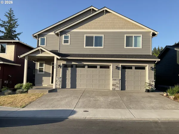 a front view of a house with a yard and garage