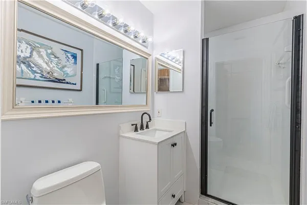 a bathroom with a sink mirror and toilet
