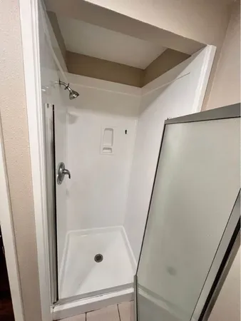 a bathroom with a glass shower door