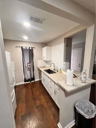 a kitchen with sink stove and cabinets