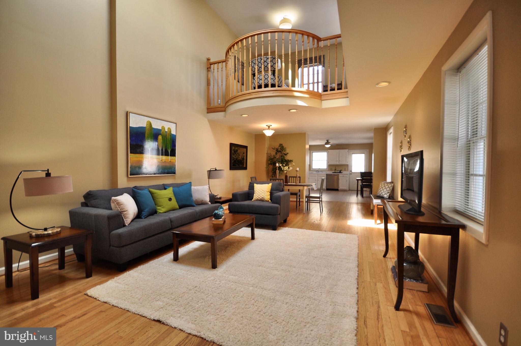1200 Riverside Avenue Baltimore, MD 21230 - Photo 1 of 30 a living room with furniture a flat screen tv and a large window