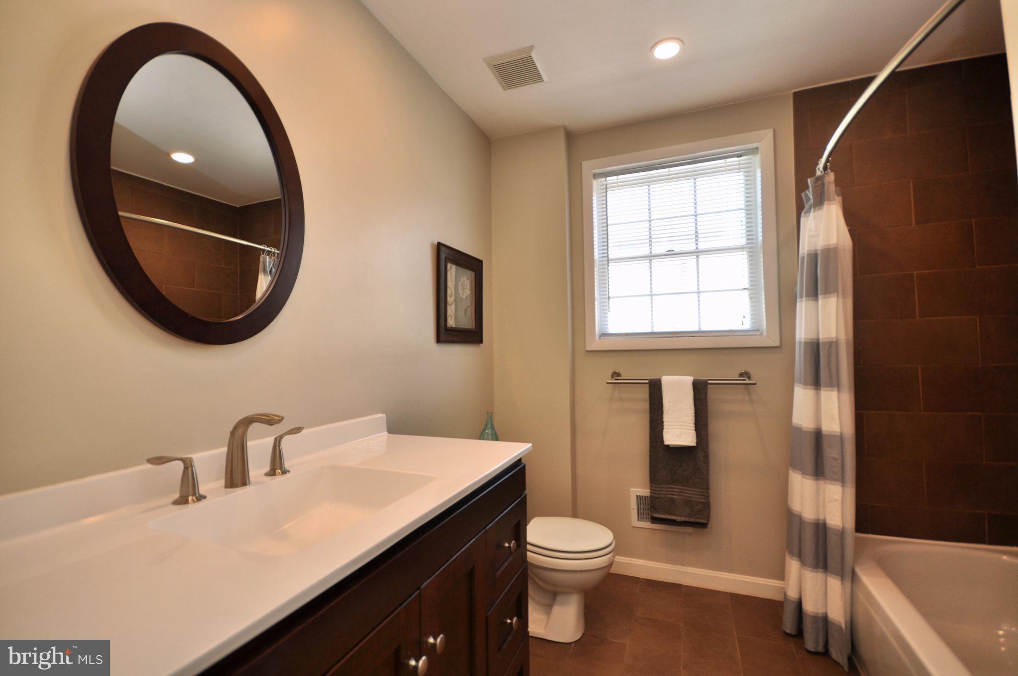 1200 Riverside Avenue Baltimore, MD 21230 - Photo 20 of 30 a bathroom with a sink a toilet and a mirror