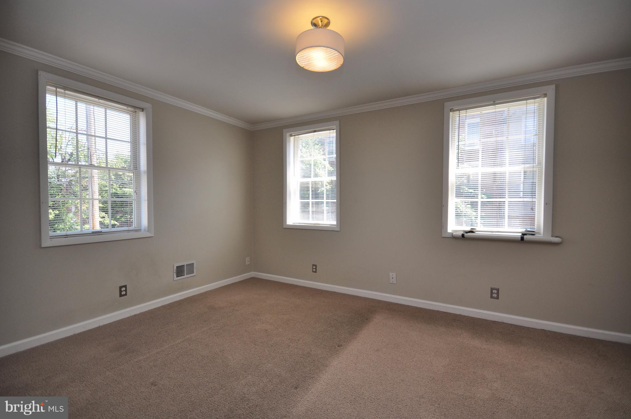 1200 Riverside Avenue Baltimore, MD 21230 - Photo 21 of 30 a view of an empty room with a window and wooden floor