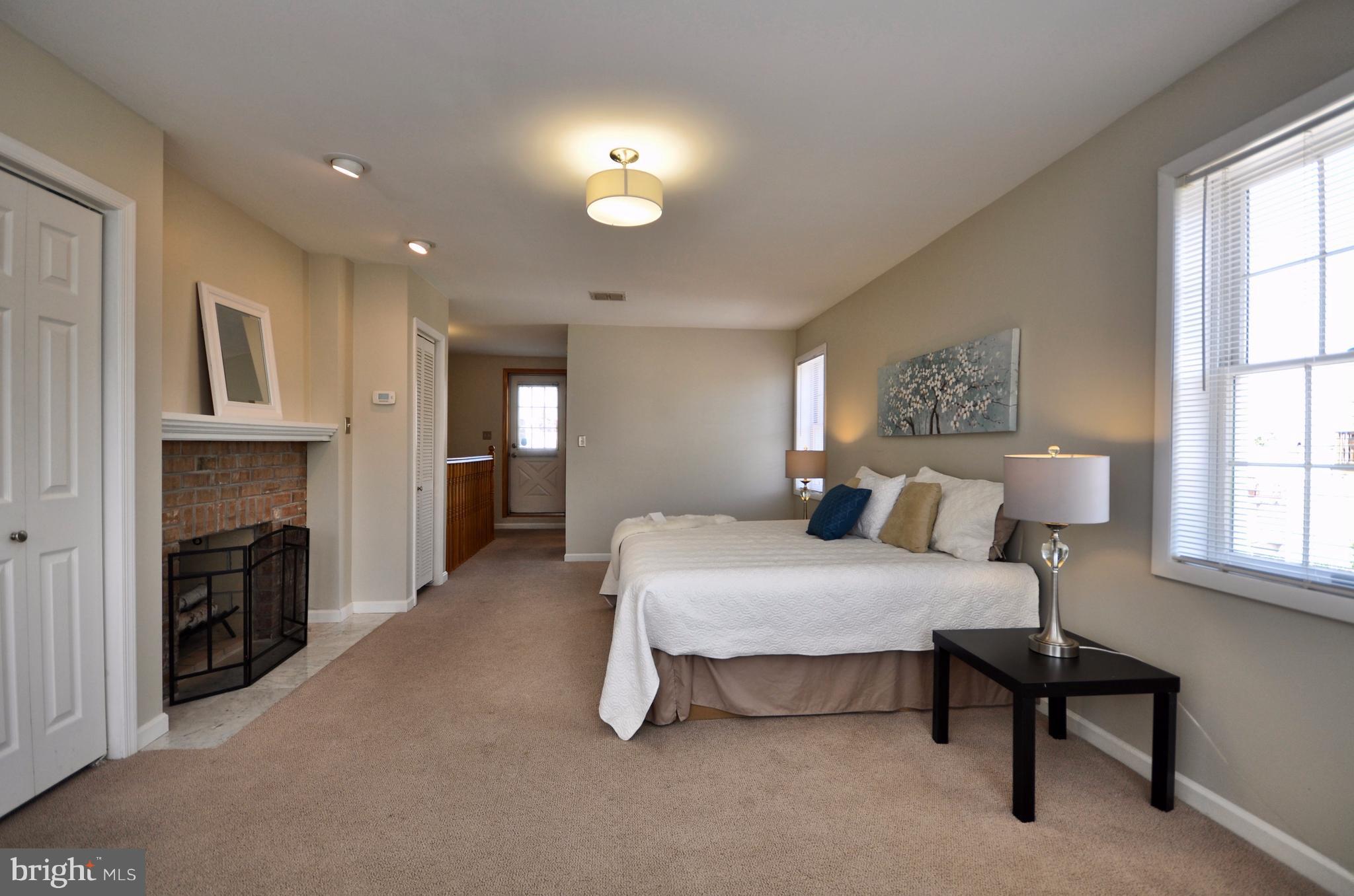 1200 Riverside Avenue Baltimore, MD 21230 - Photo 24 of 30 a bedroom with a bed and a fireplace
