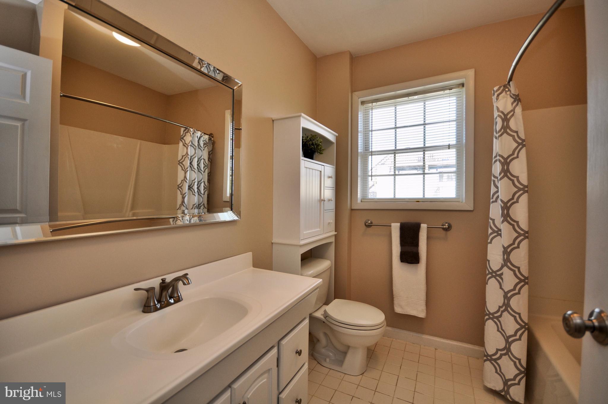 1200 Riverside Avenue Baltimore, MD 21230 - Photo 27 of 30 a bathroom with a sink a toilet and shower