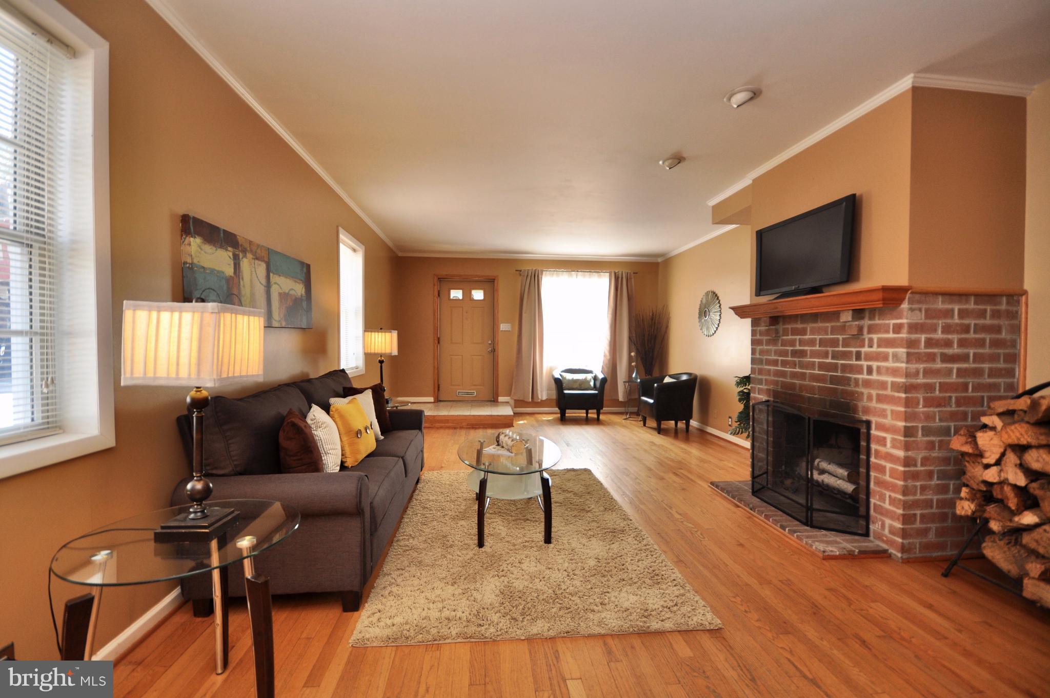 1200 Riverside Avenue Baltimore, MD 21230 - Photo 4 of 30 a living room with furniture a flat screen tv and a fireplace