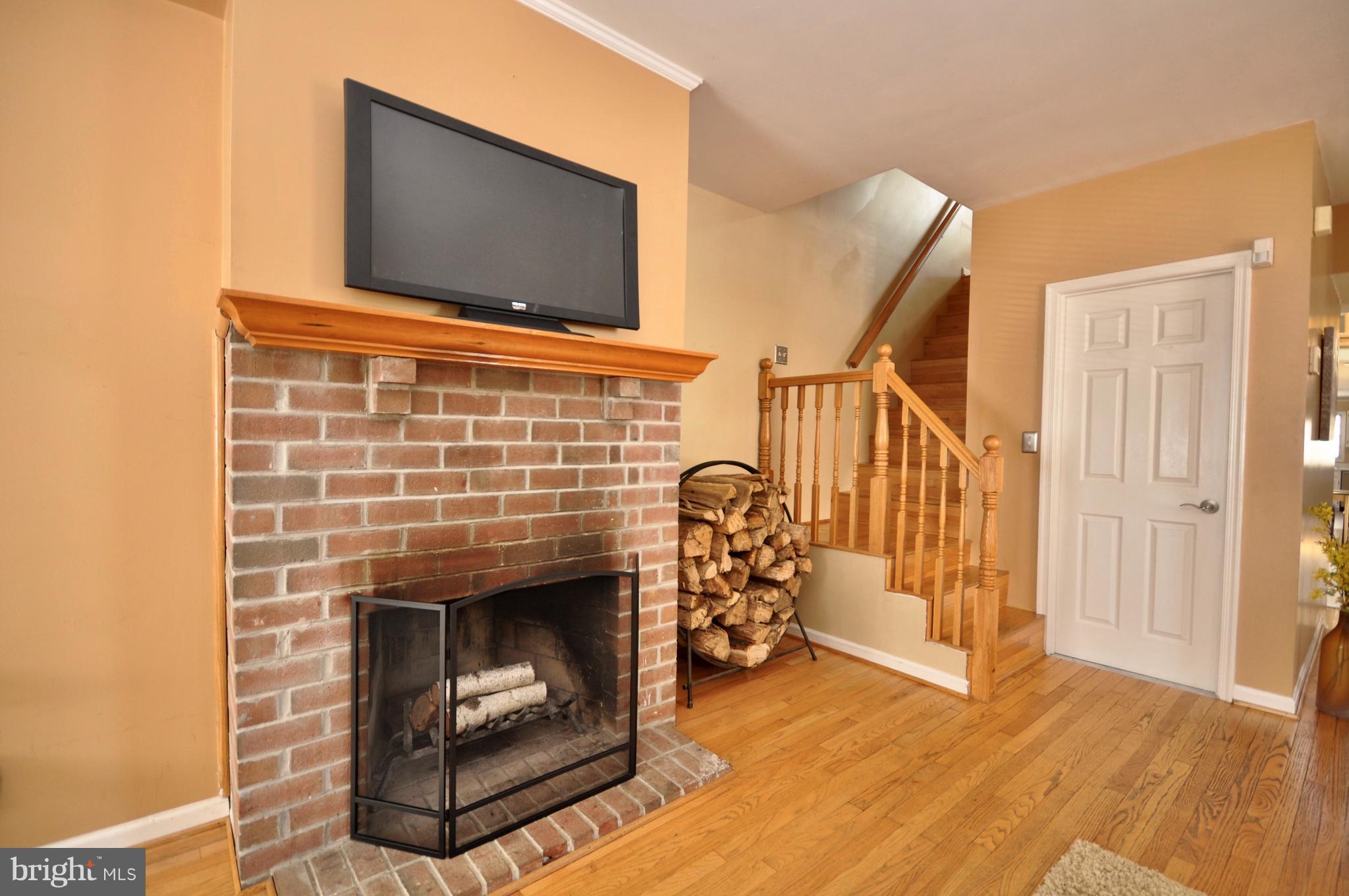 1200 Riverside Avenue Baltimore, MD 21230 - Photo 6 of 30 a living room with a fireplace and a flat screen tv