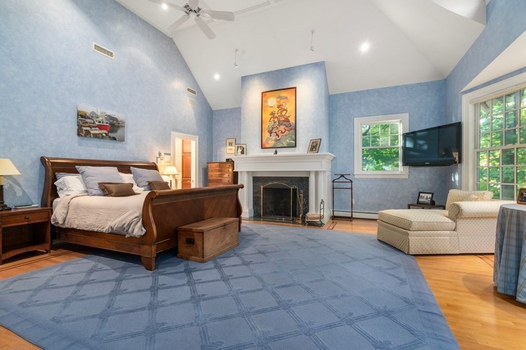 60 Abbott Road Wellesley, MA 02481 - Photo 18 of 40 a bedroom with a bed and a fireplace