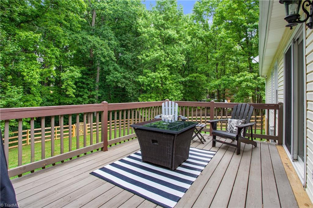 7105 Harper Ridge Court Oak Ridge, NC 27310 - Photo 19 of 23 Large deck off kitchen overlooks private backyard. Large portion has new fence added!