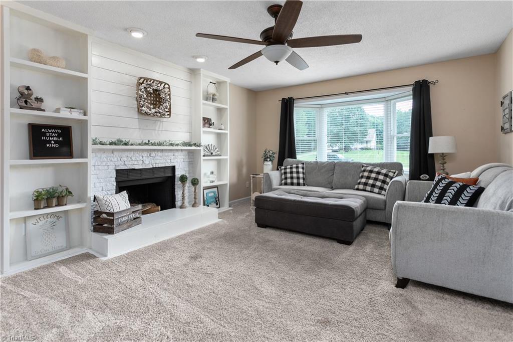 7105 Harper Ridge Court Oak Ridge, NC 27310 - Photo 5 of 23 Cute and welcoming den, accented with shiplap, built-ins and fireplace.