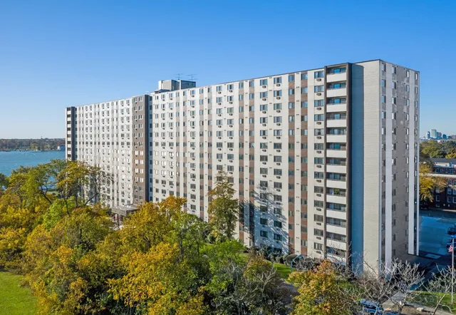 a front view of a building with a garden