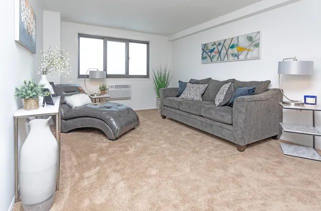 a living room with furniture and a large window