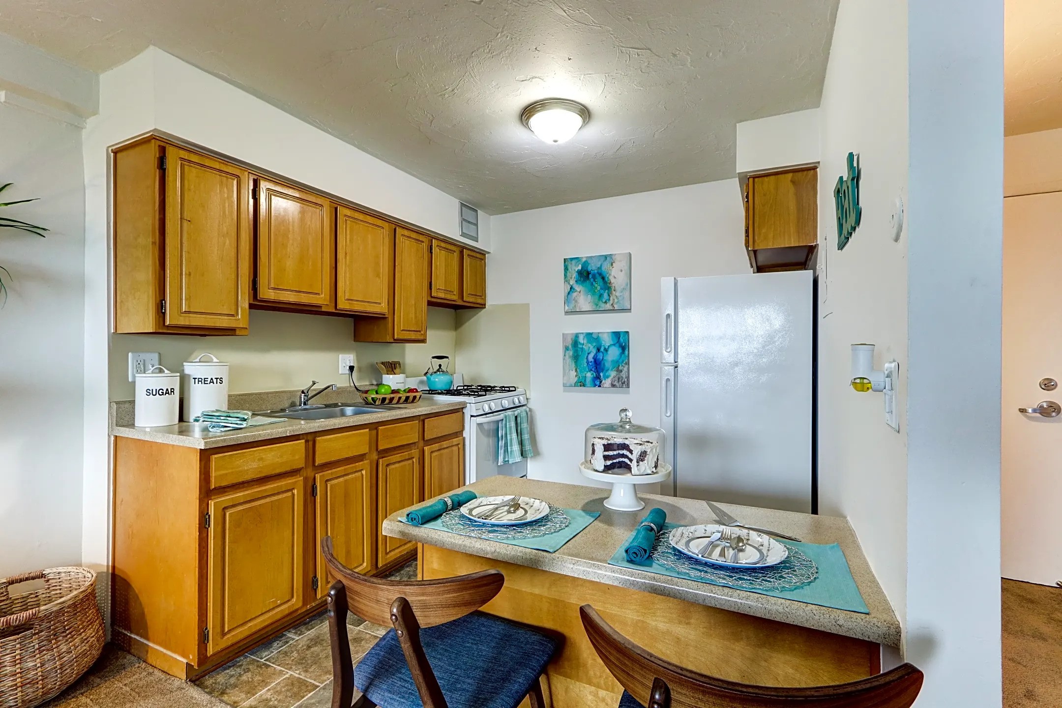 7800 East Jefferson Detroit, MI 48214 - Photo 5 of 6 a kitchen with stainless steel appliances granite countertop a sink a stove a refrigerator with a dining table and chairs