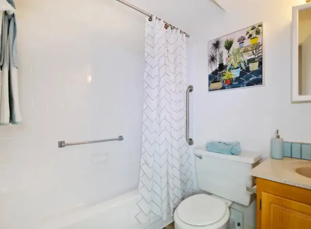 a white toilet sitting next to a bathroom sink