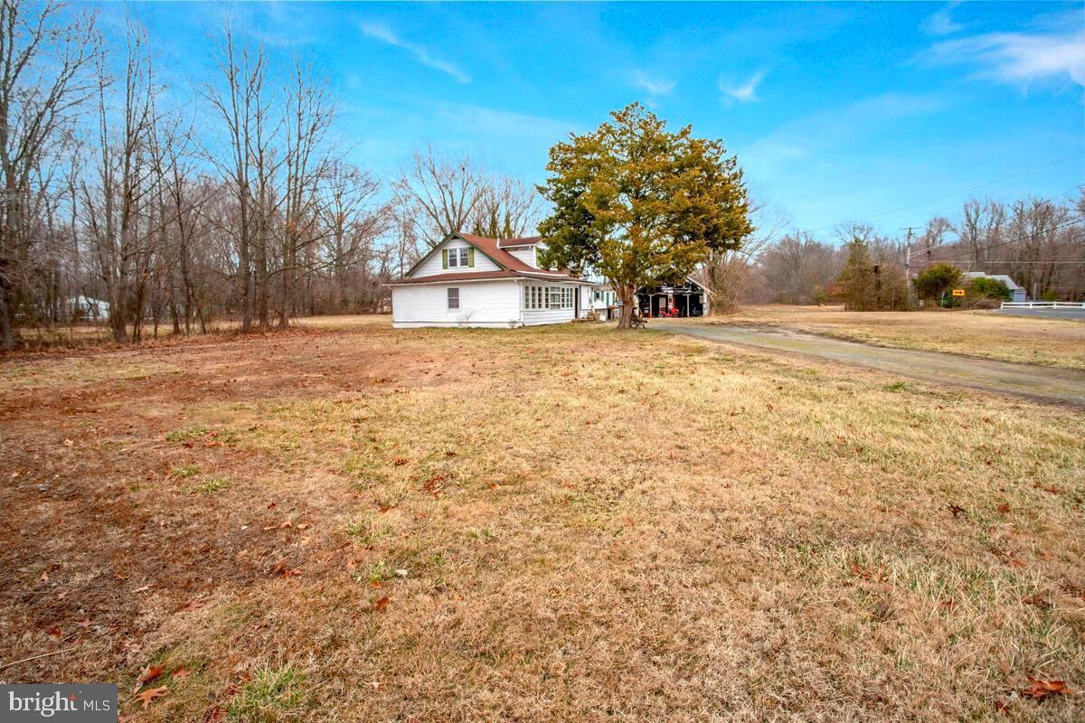 6037 Drum Point Road Deale, MD 20751 - Photo 1 of 4 a street view with large trees