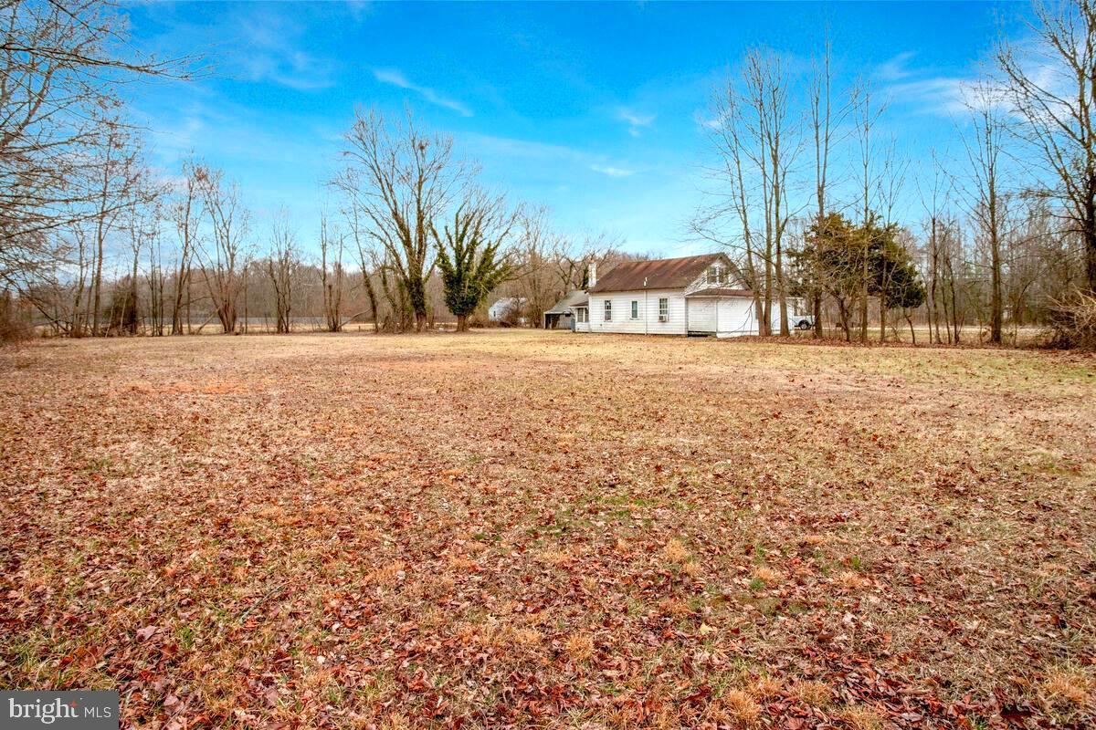 6037 Drum Point Road Deale, MD 20751 - Photo 3 of 4 a view of a yard with a house