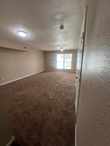 an empty room with windows and closet
