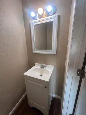 a bathroom with a sink a mirror and a toilet