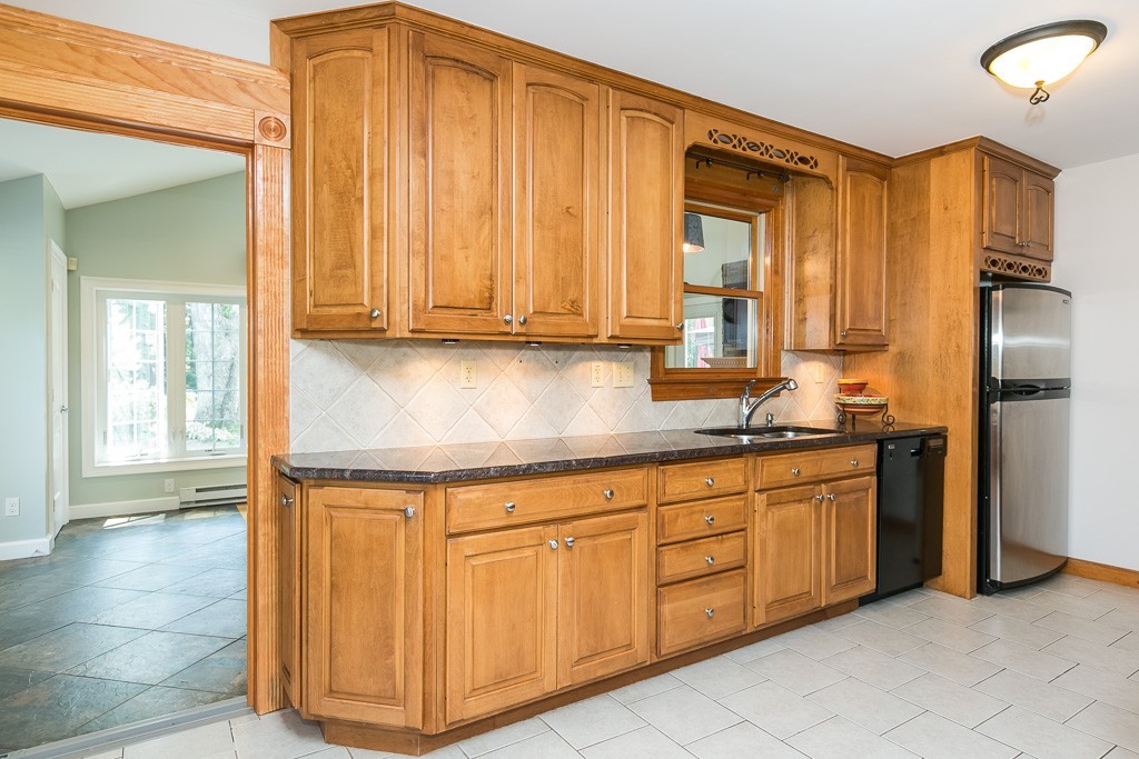 387 Maple Road Longmeadow, MA 01106 - Photo 7 of 27 a kitchen with stainless steel appliances granite countertop a sink and cabinets