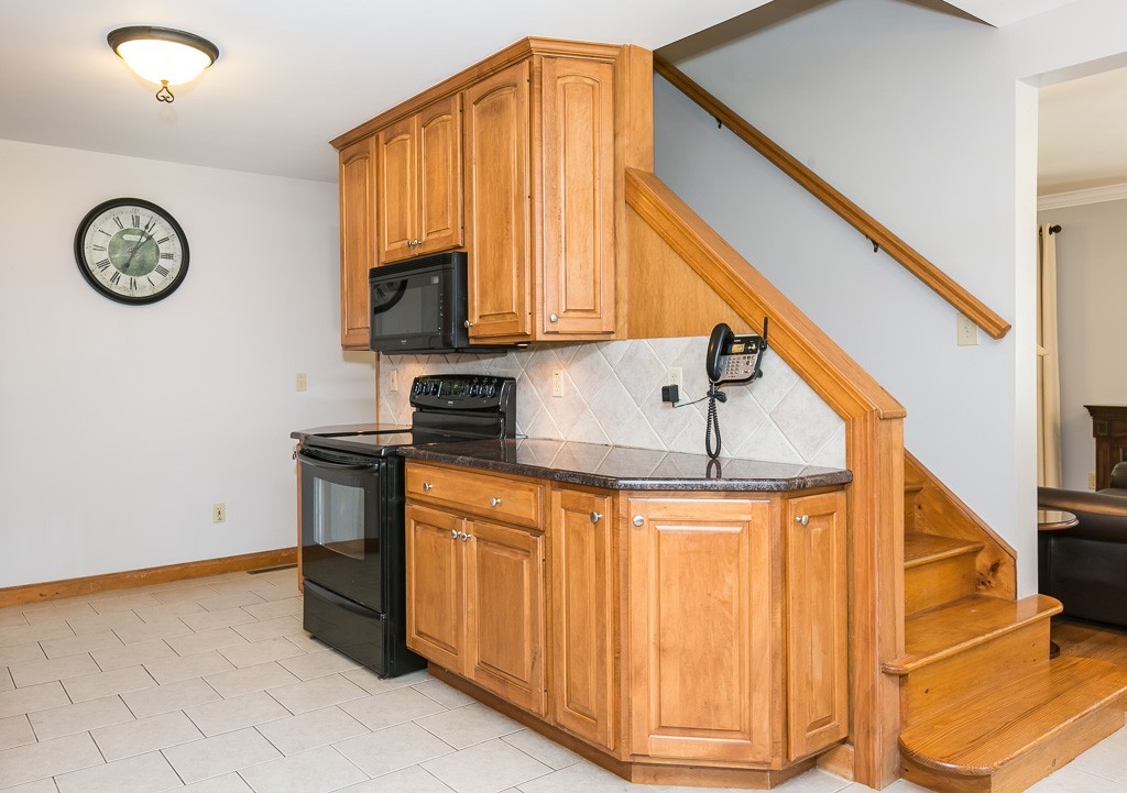 387 Maple Road Longmeadow, MA 01106 - Photo 8 of 27 a kitchen with stainless steel appliances granite countertop a refrigerator a stove and a sink