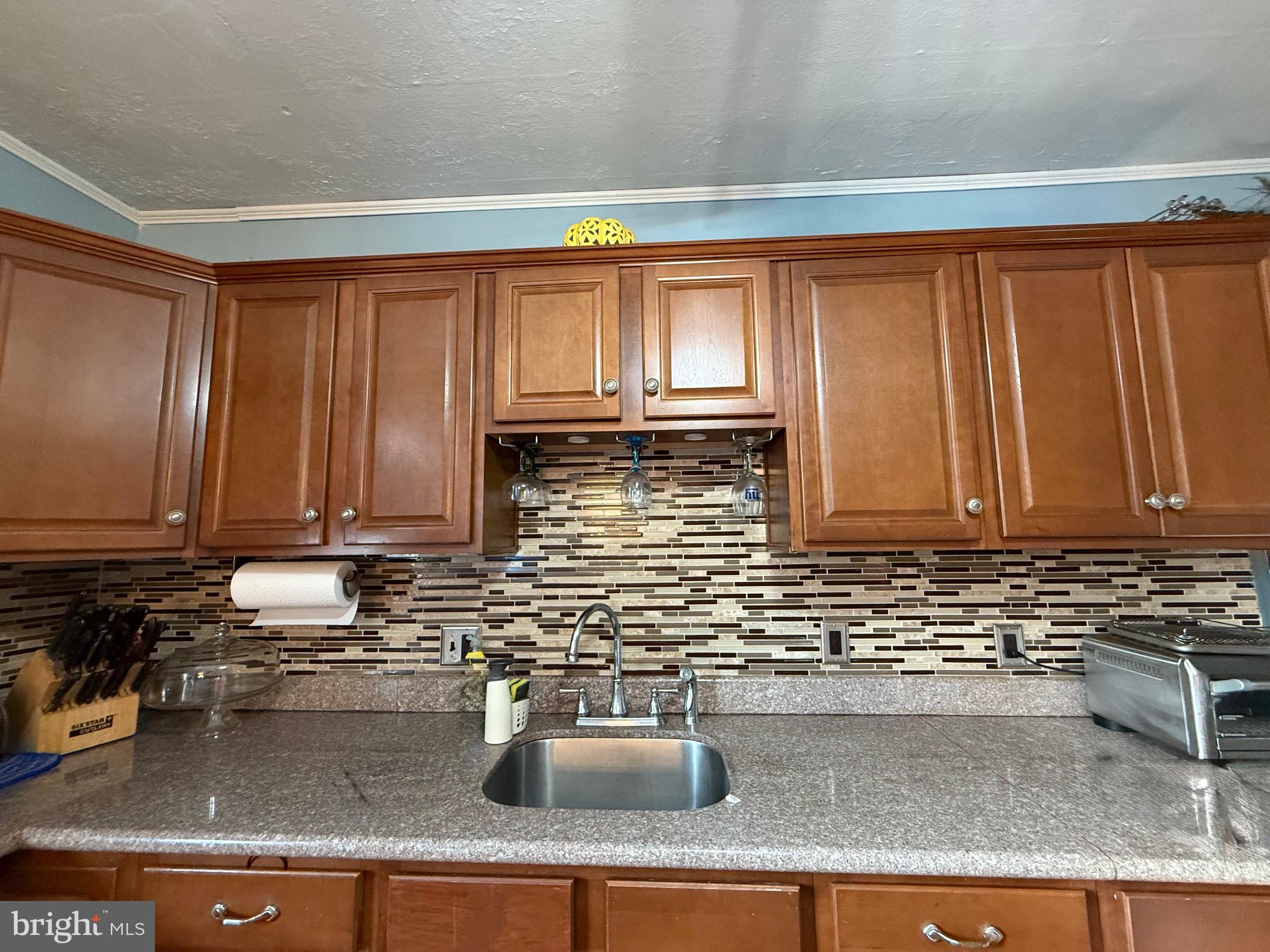 531 6th Avenue Lindenwold, NJ 08021 - Photo 2 of 10 a kitchen with granite countertop a sink a stove and cabinets
