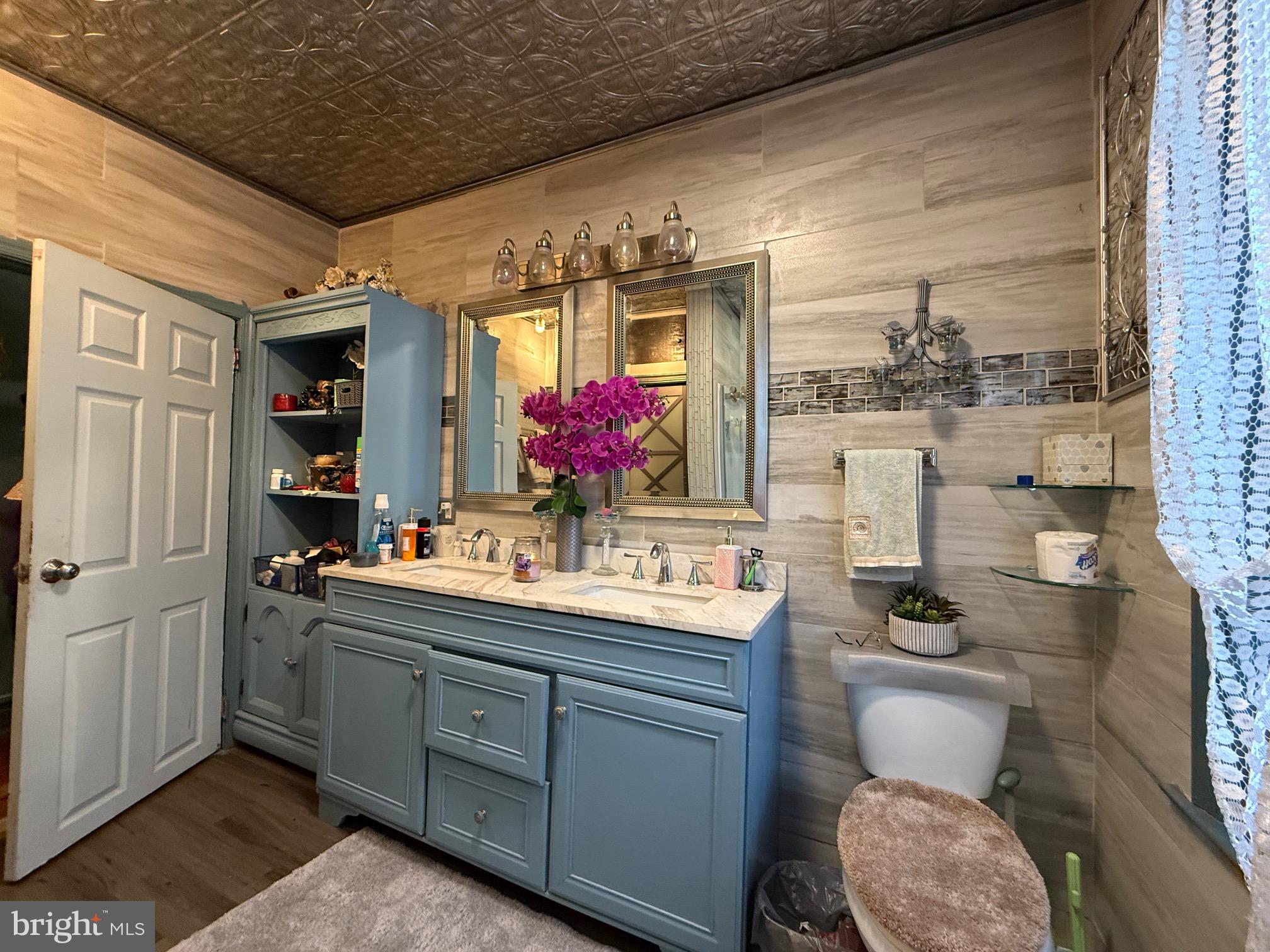 531 6th Avenue Lindenwold, NJ 08021 - Photo 3 of 10 a bathroom with a toilet a sink and mirror