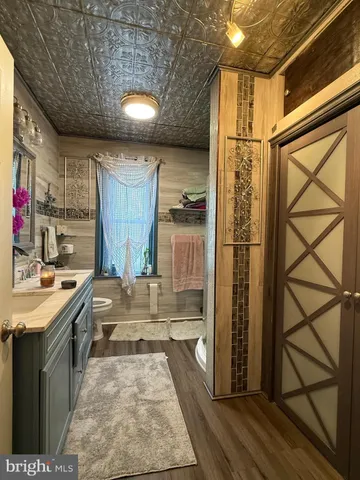 a view of a kitchen with a sink and a refrigerator