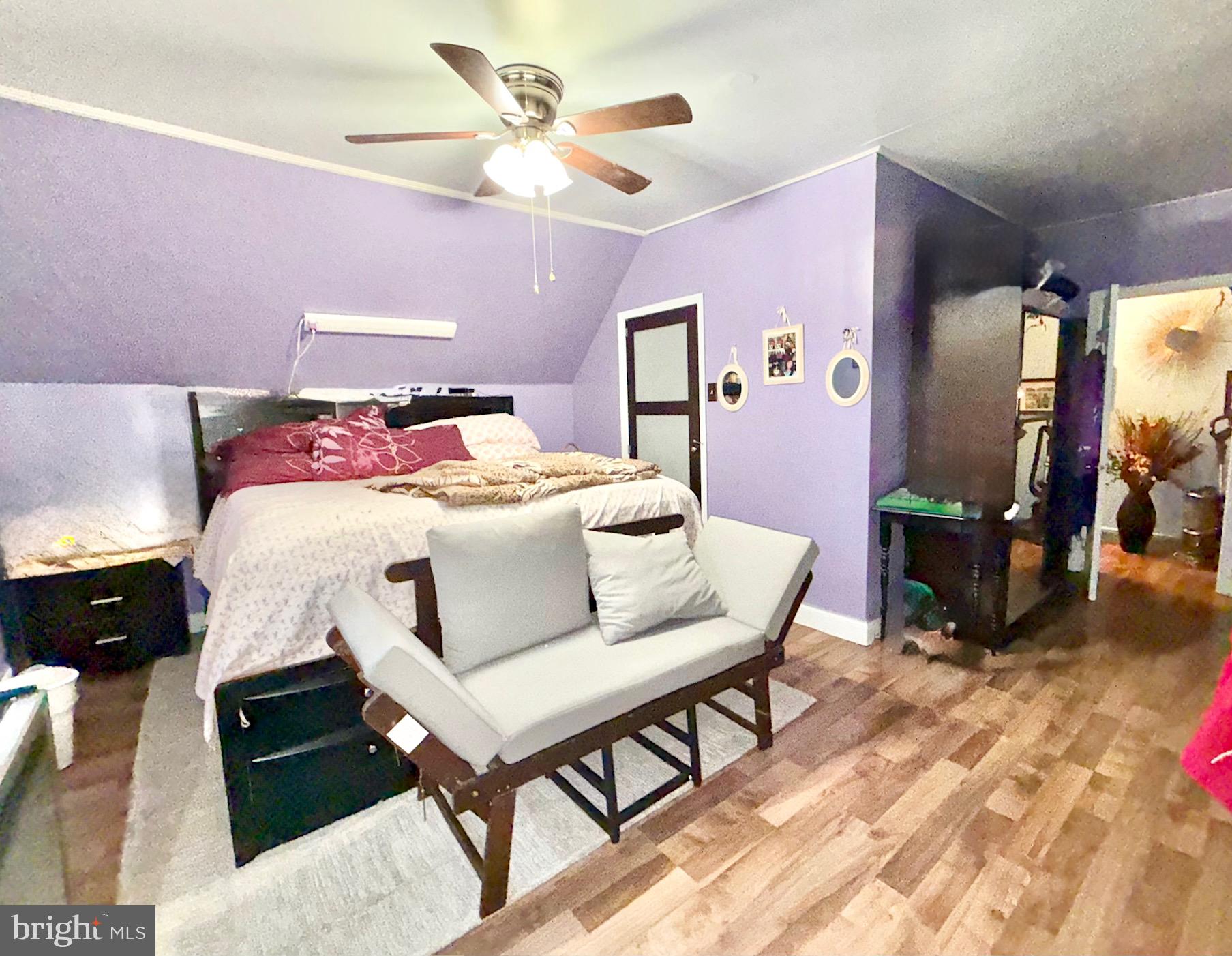 531 6th Avenue Lindenwold, NJ 08021 - Photo 7 of 10 a bedroom with a bed a chandelier and dresser