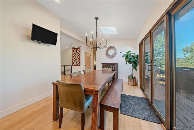 a dining room with furniture a chandelier and window