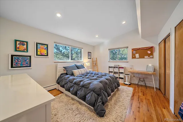 a bed room with a bed and a dresser