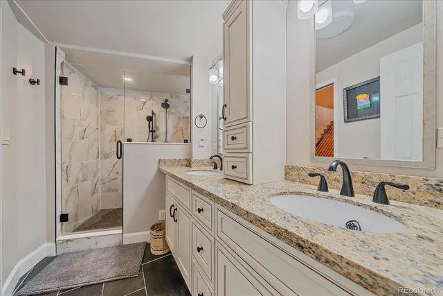 a living room with furniture a fireplace and a large window