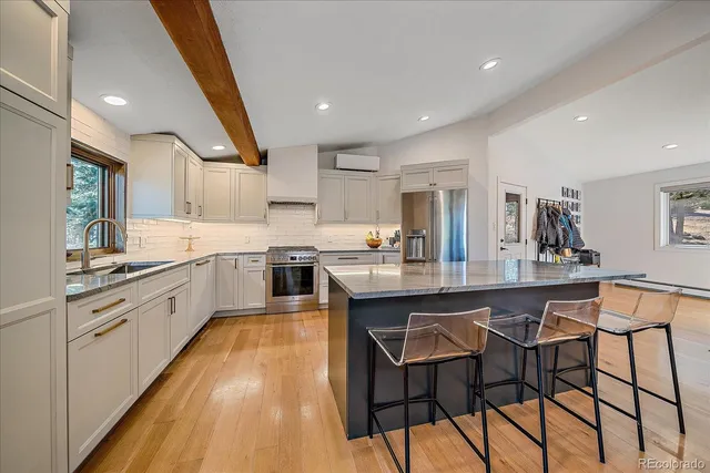 a large kitchen with stainless steel appliances lots of counter space and breakfast area